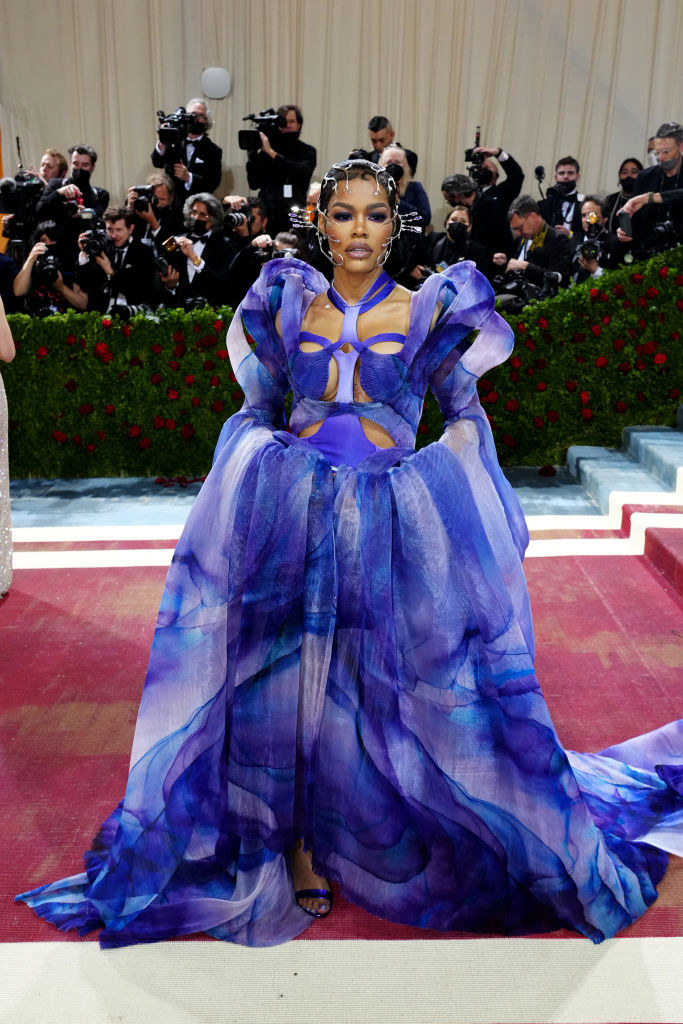 Teyana Taylor in a metal jeweled headpiece and a tie-dyed ballgown with a train