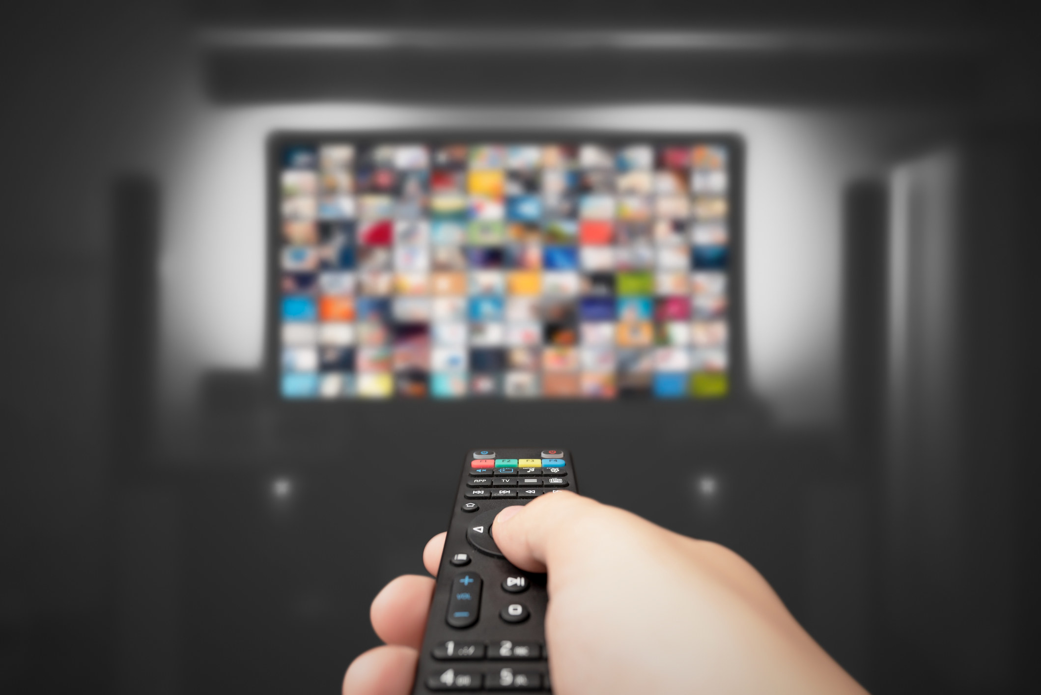 A person using a remote control for their TV.