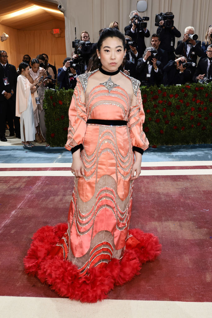 Awkwafina in a long-sleeved gown with a poufy bottom