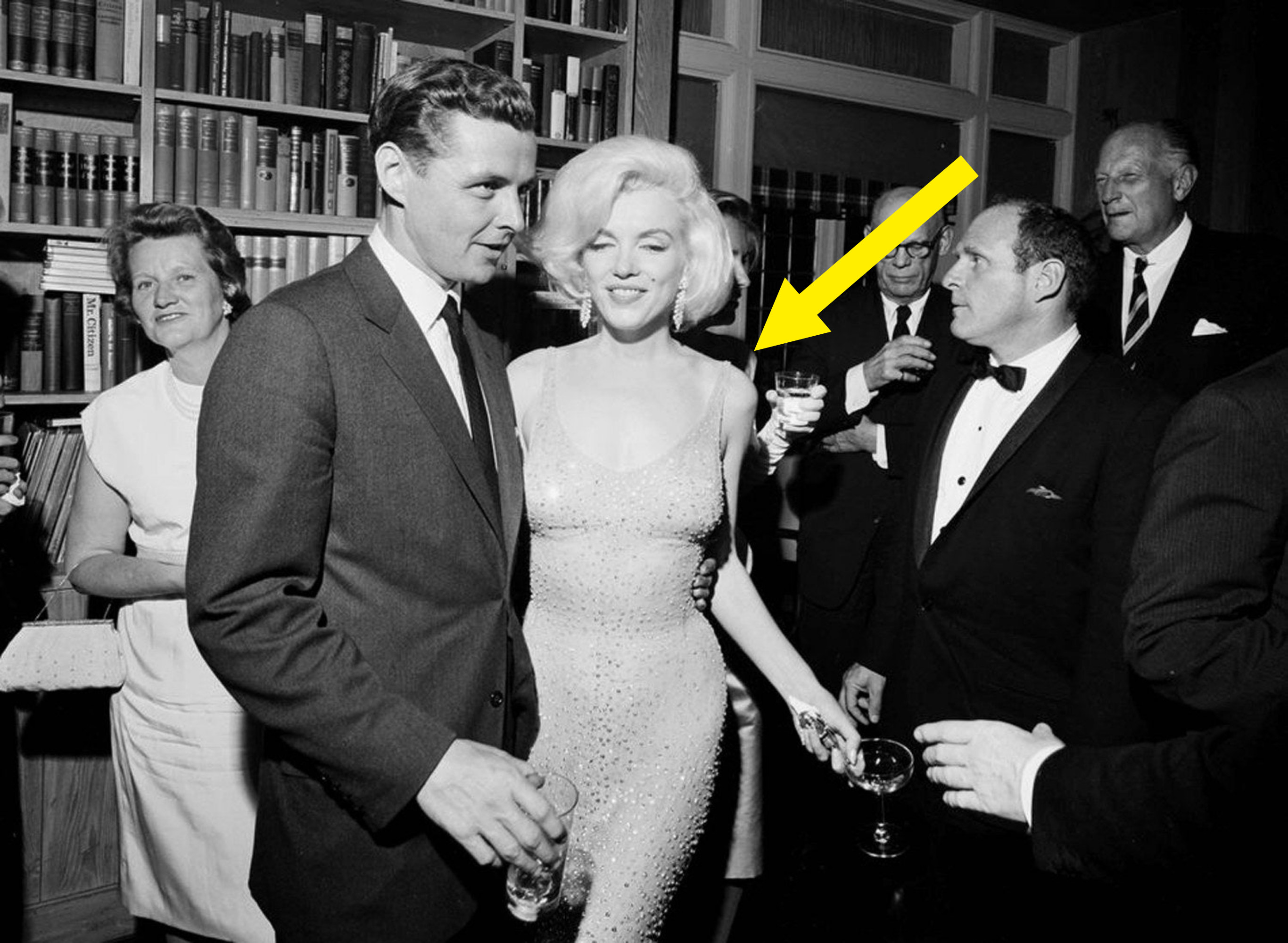 Marilyn Monroe wearing the dress and smiling amongst a group of people