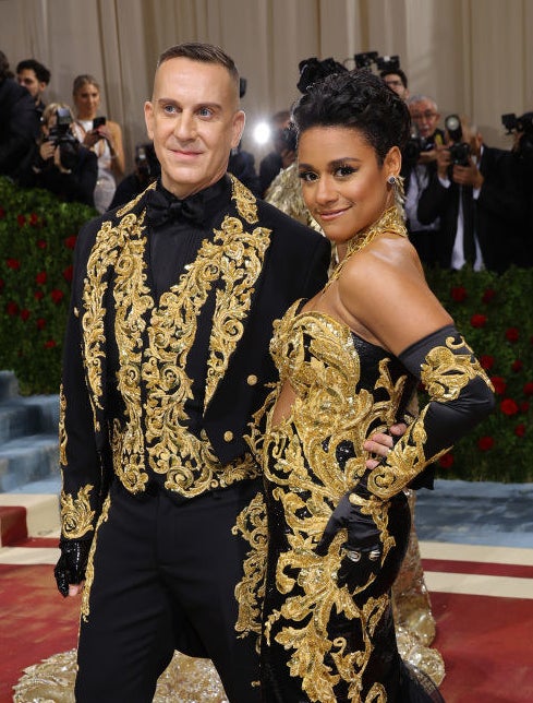A closeup of Ariana DeBose and Jeremy Scott in the matching gold-embroidered outfits