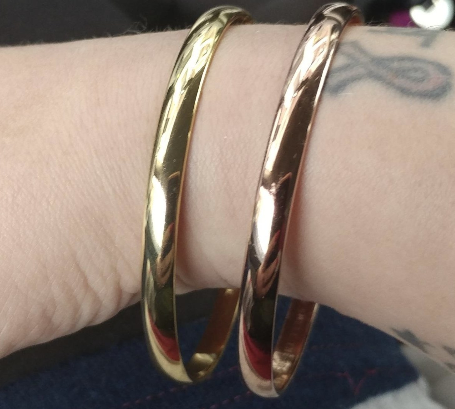 reviewer wearing the two Kate Spade bangles