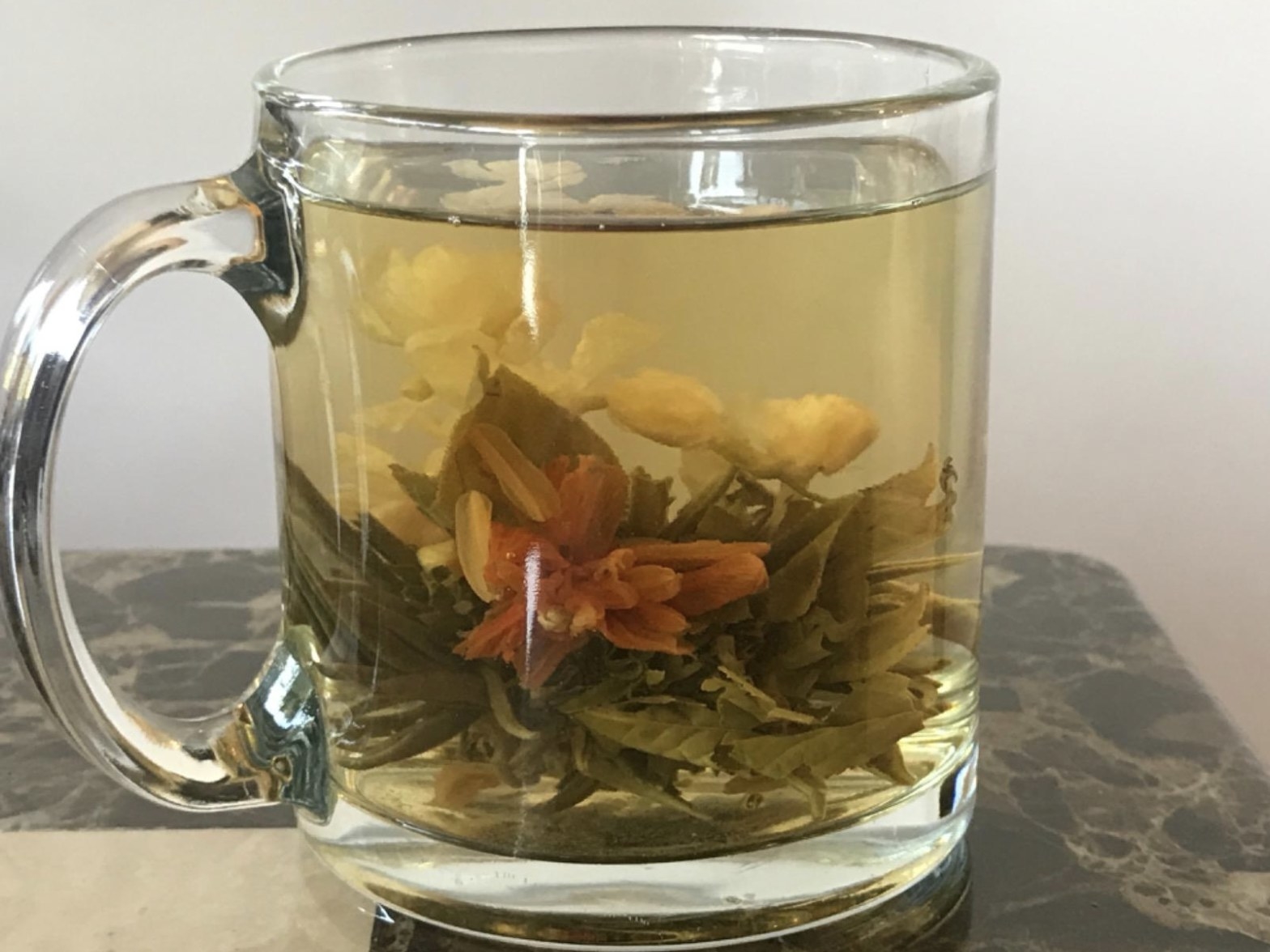 reviewer photo showing the tea bloom inside their glass tea mug