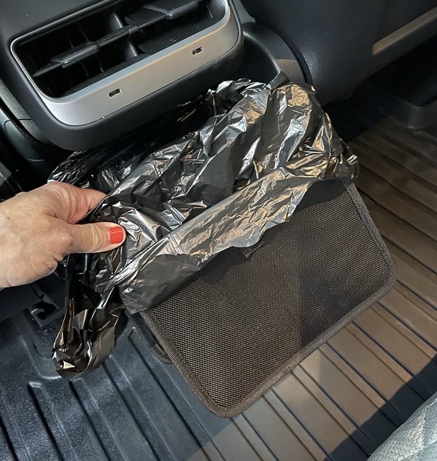 reviewer holding the car trash bag