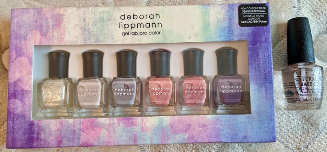 A reviewer&#x27;s set of colorful nail polishes, this set has white, pink and purple shades in it.