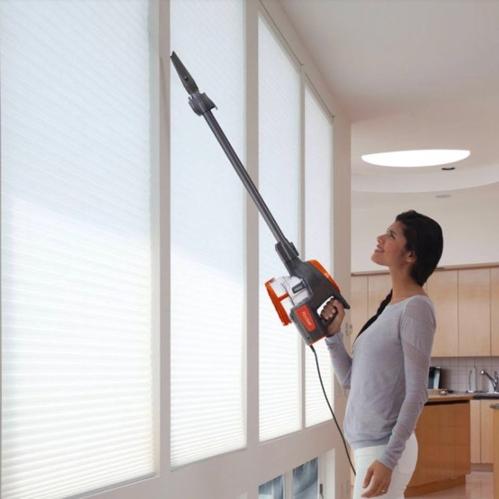 Model using vacuum on blinds