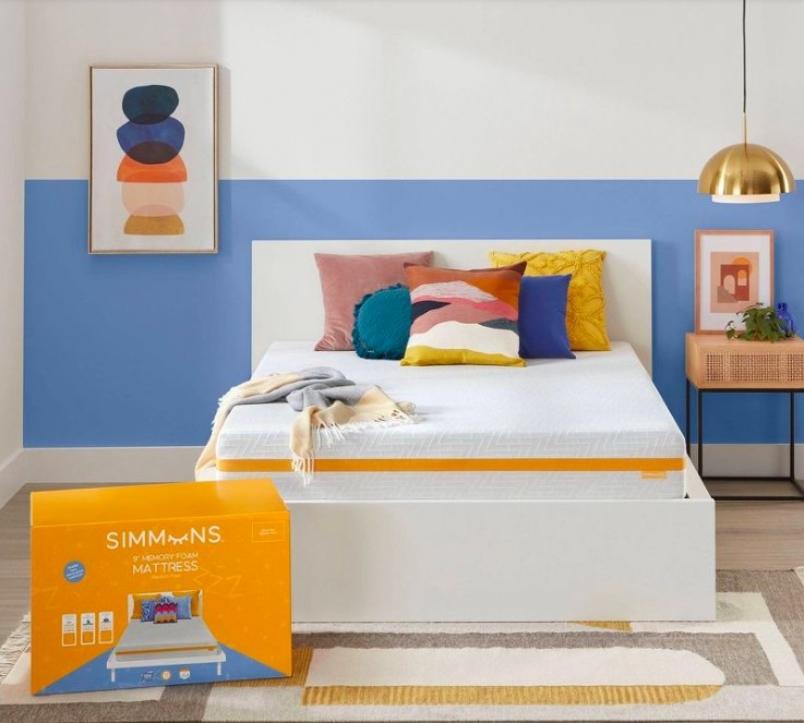 Mattress on a bed with colorful pillows