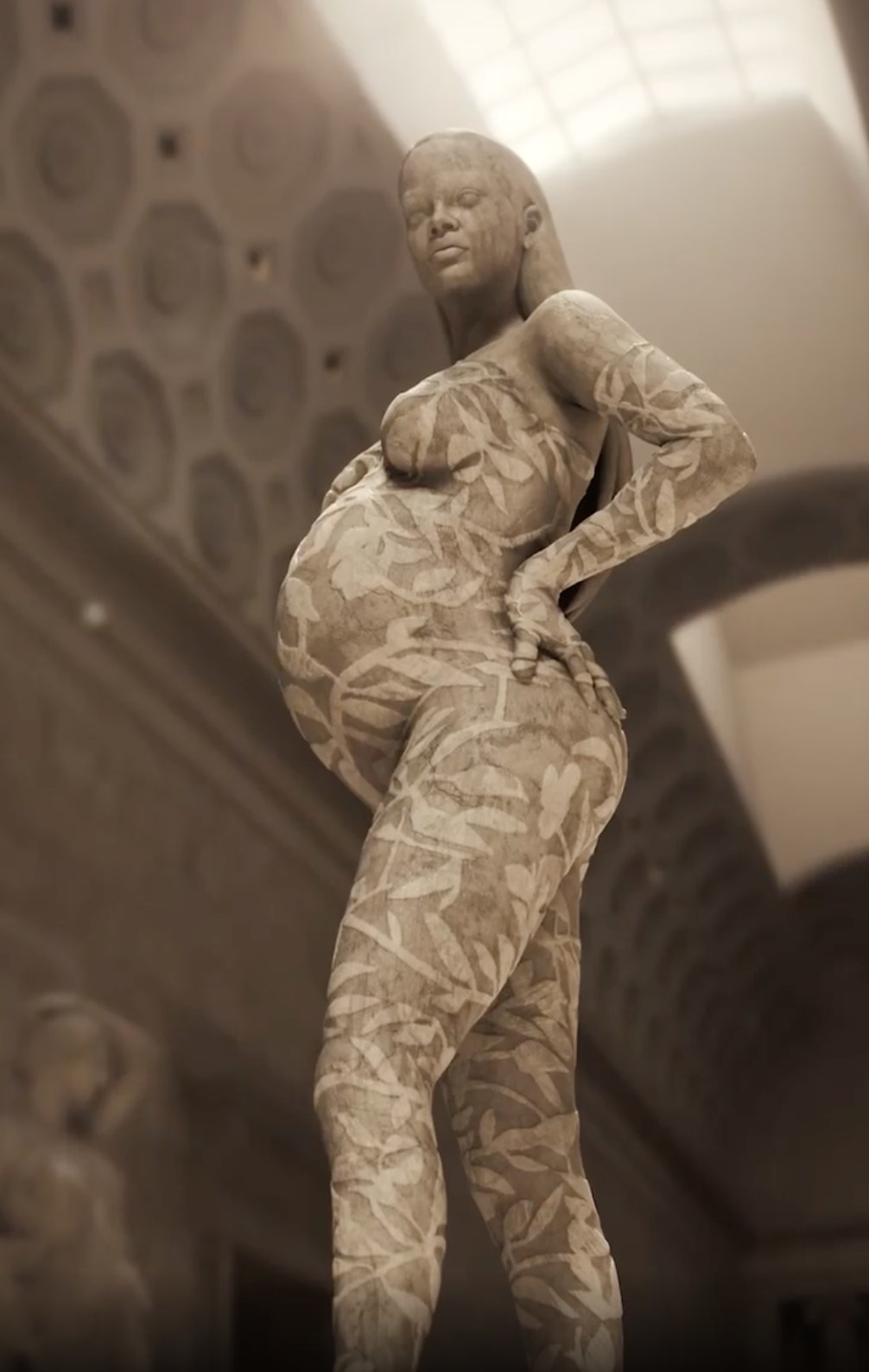 A large beige statue of Rihanna in a lace jumpsuit with a baby bump