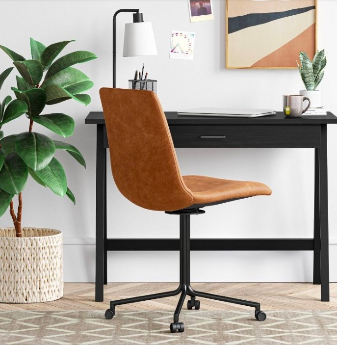 Faux leather chair next to a black desk