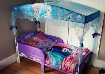 reviewer's photo of the Frozen themed bed with canopy