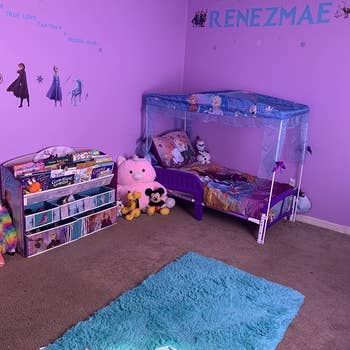 reviewer's photo of the Frozen themed bed in a kids' room