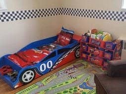 reviewer's photo of the bed in a car themed room