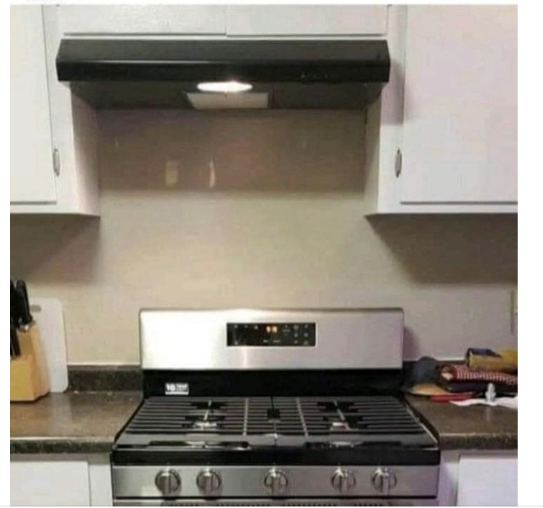 A stove not aligned with hood above it