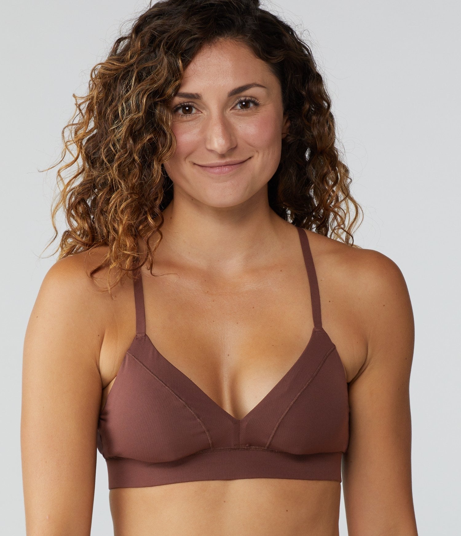 model in a dark brown bralette with triangle cups