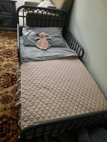 reviewer's photo of the grey metal bed