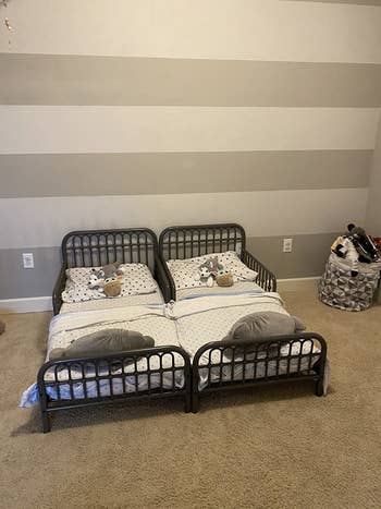 reviewer's photo of two grey metal beds