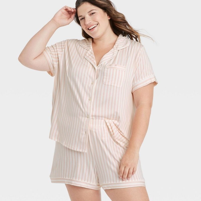 A model wearing the pajamas in the color Light Pink