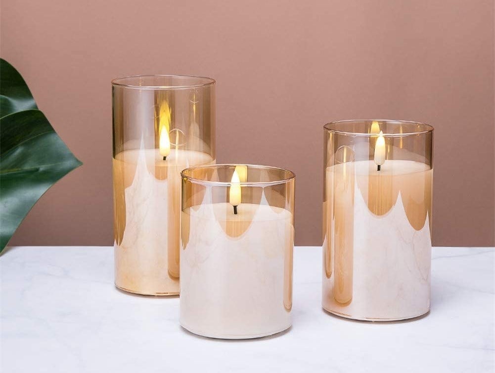 a trio of flameless candles in glass votives