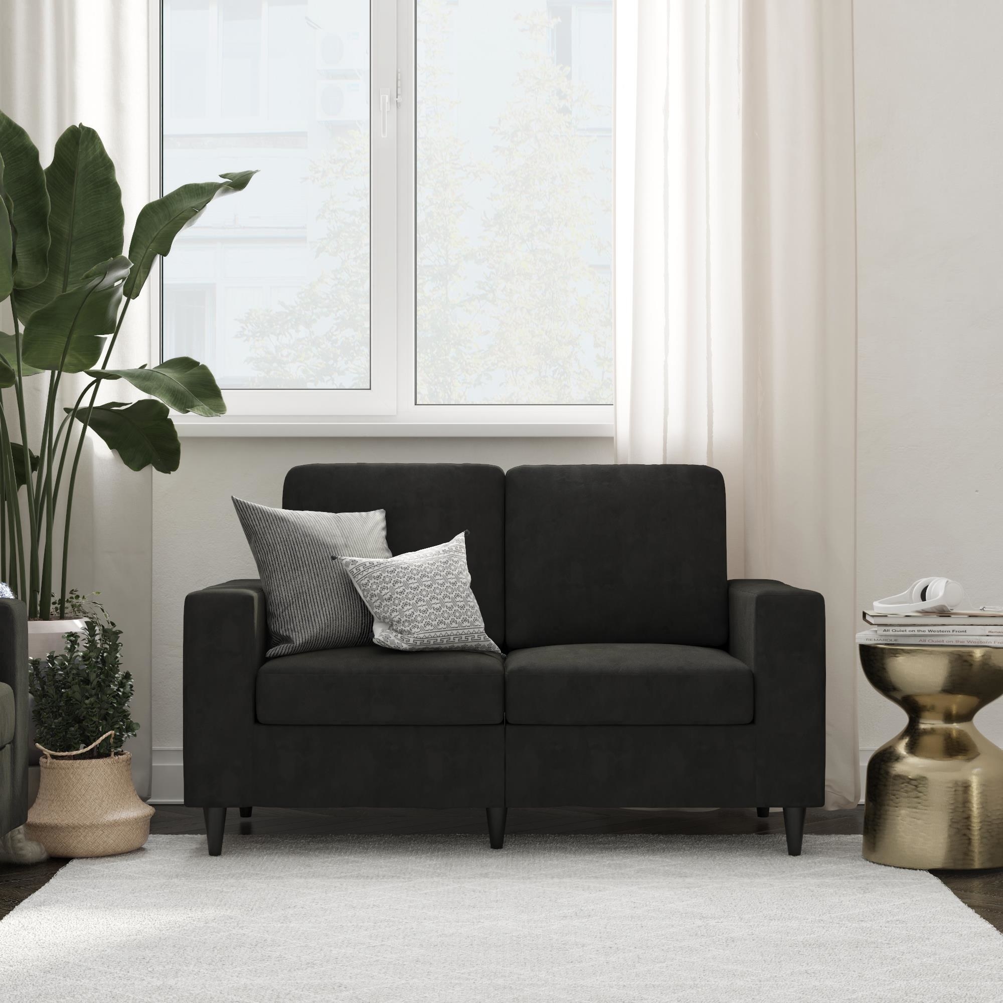 An image of a black loveseat with a sturdy wooden frame, pocket coiled seats, and solid wood legs