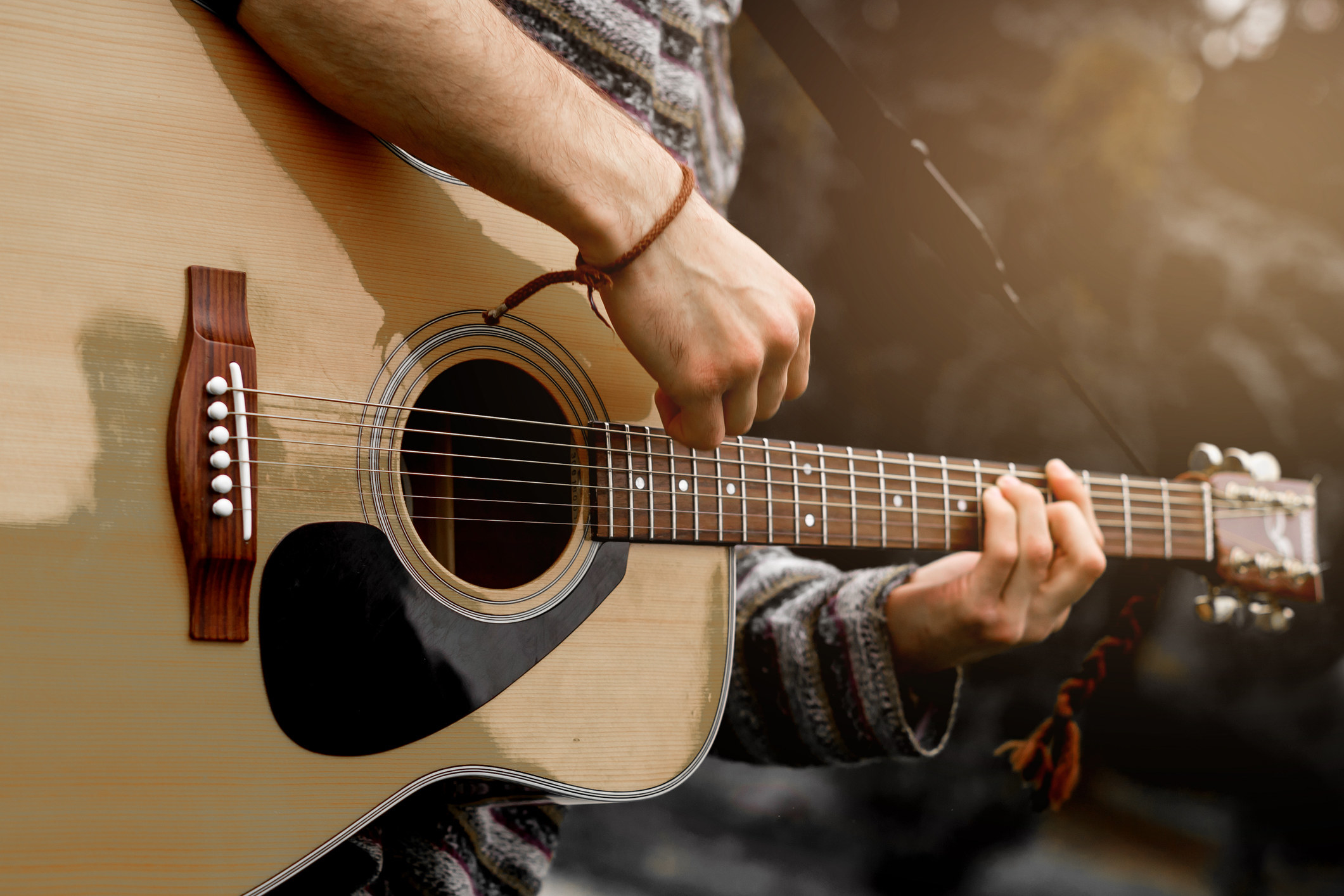 A man plays the acoustic guitar