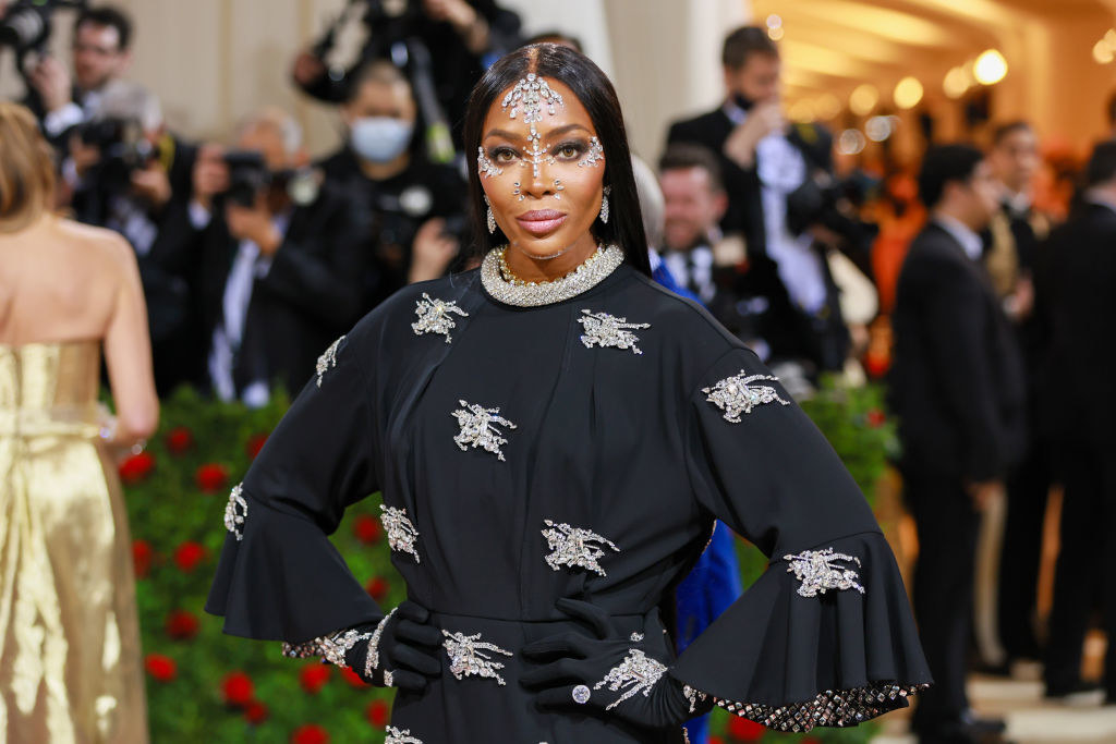 Naomi Campbell wearing a jeweled gown and matching face jewelry