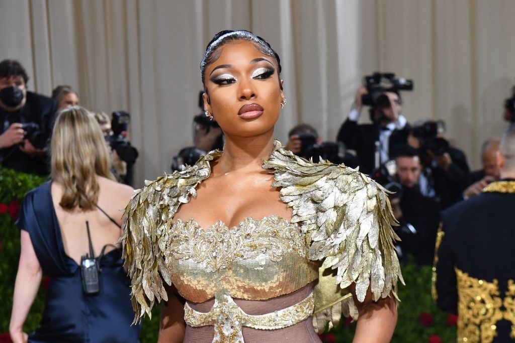 Megan Thee Stallion wearing the gold-dipped feather dress