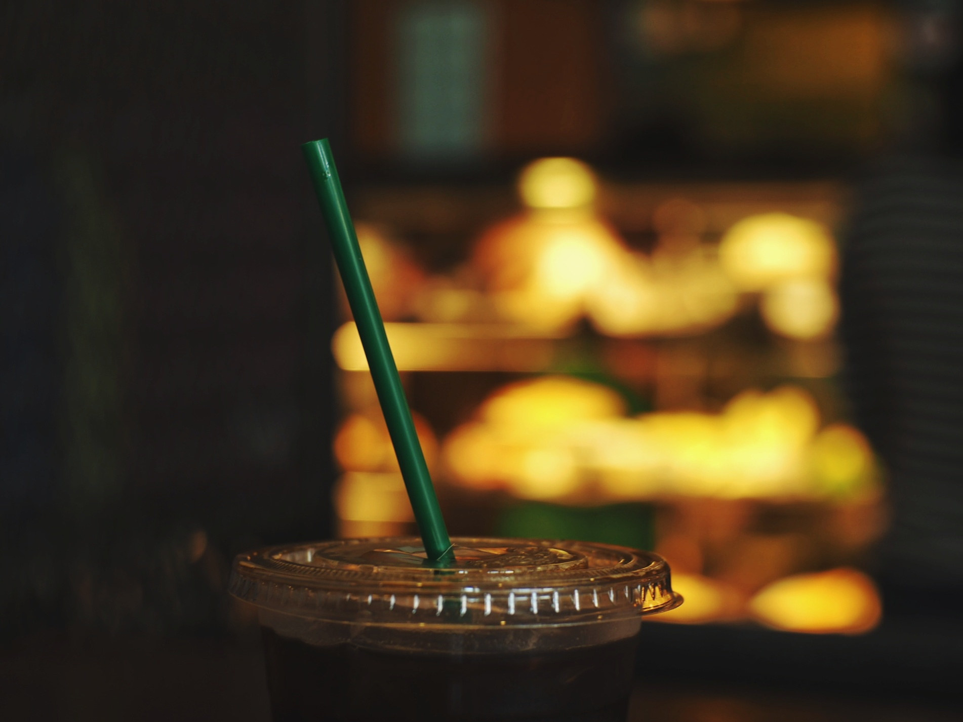 An iced coffee with a straw sticking out of it