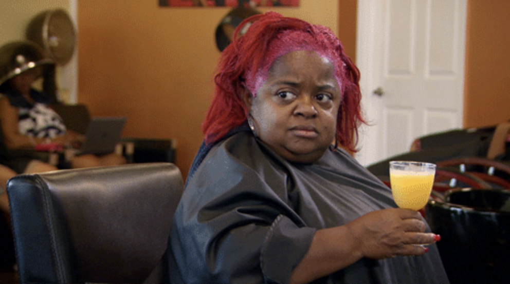 A woman at a salon looking over at someone with confusion