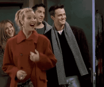 Friends&#x27; Phoebe jumping up and down excitedly while Rachel, Ross, and Chandler smile behind her