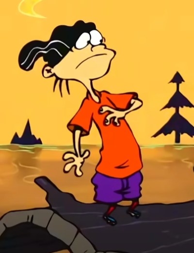Edd standing on a log looking at Eddy
