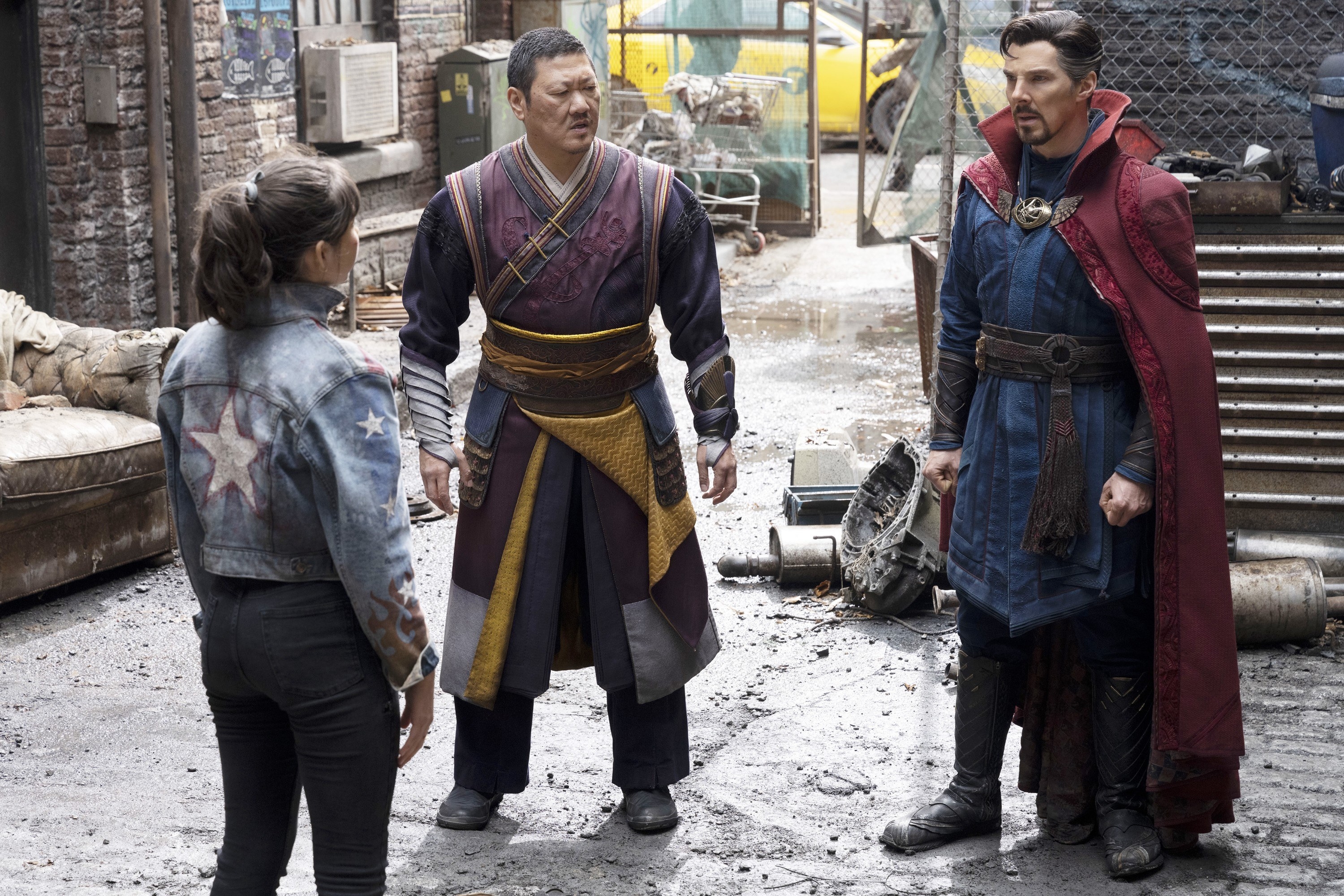 Strange, Wong, and Chavez stand together in an alleyway