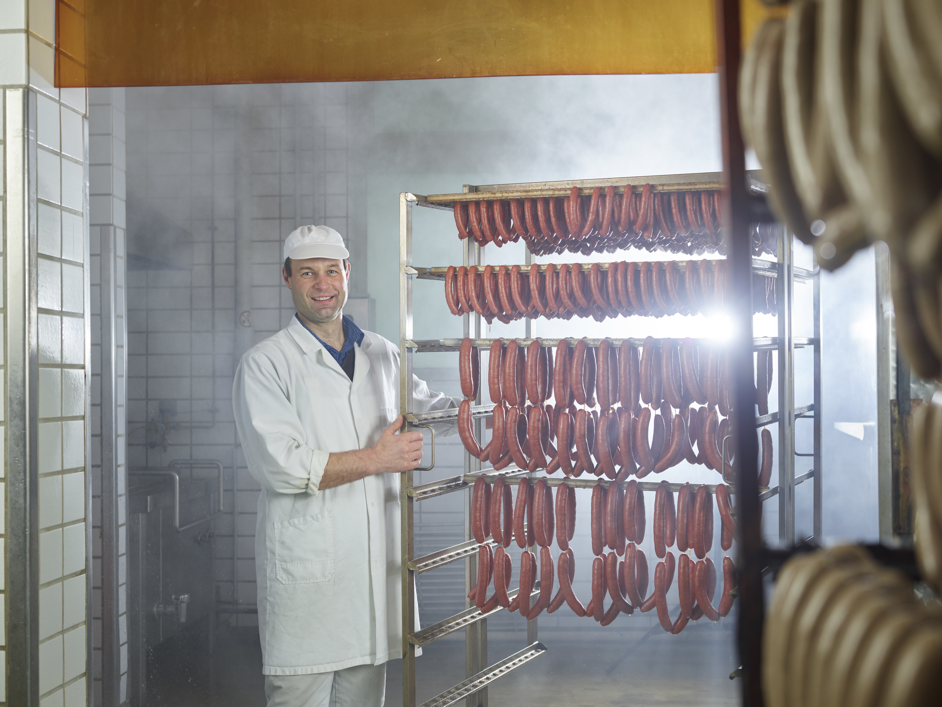 Man stands with a sausage rack