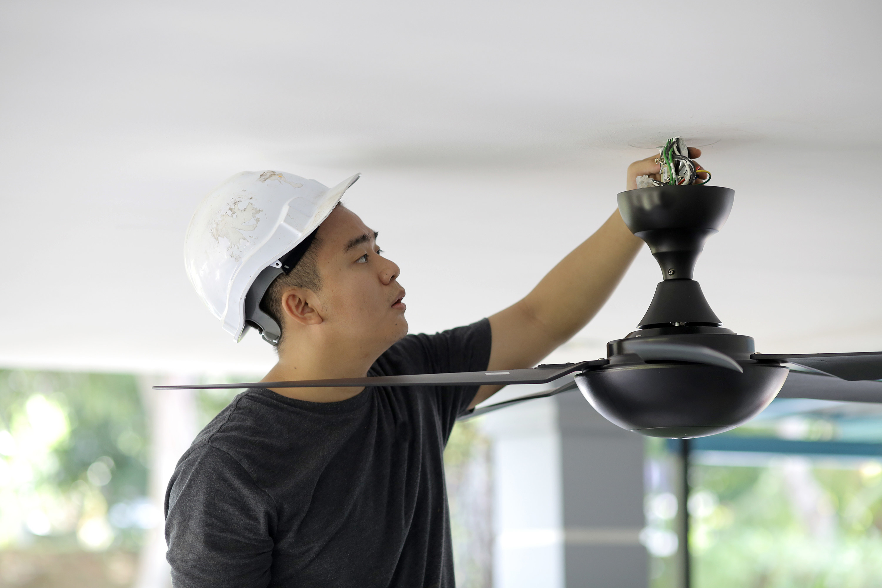 Man changes ceiling fan