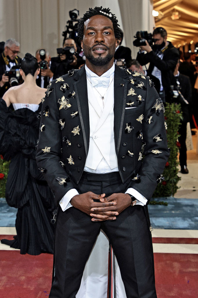 Yahya in a tuxedo with a blazer embellished with gold flowers