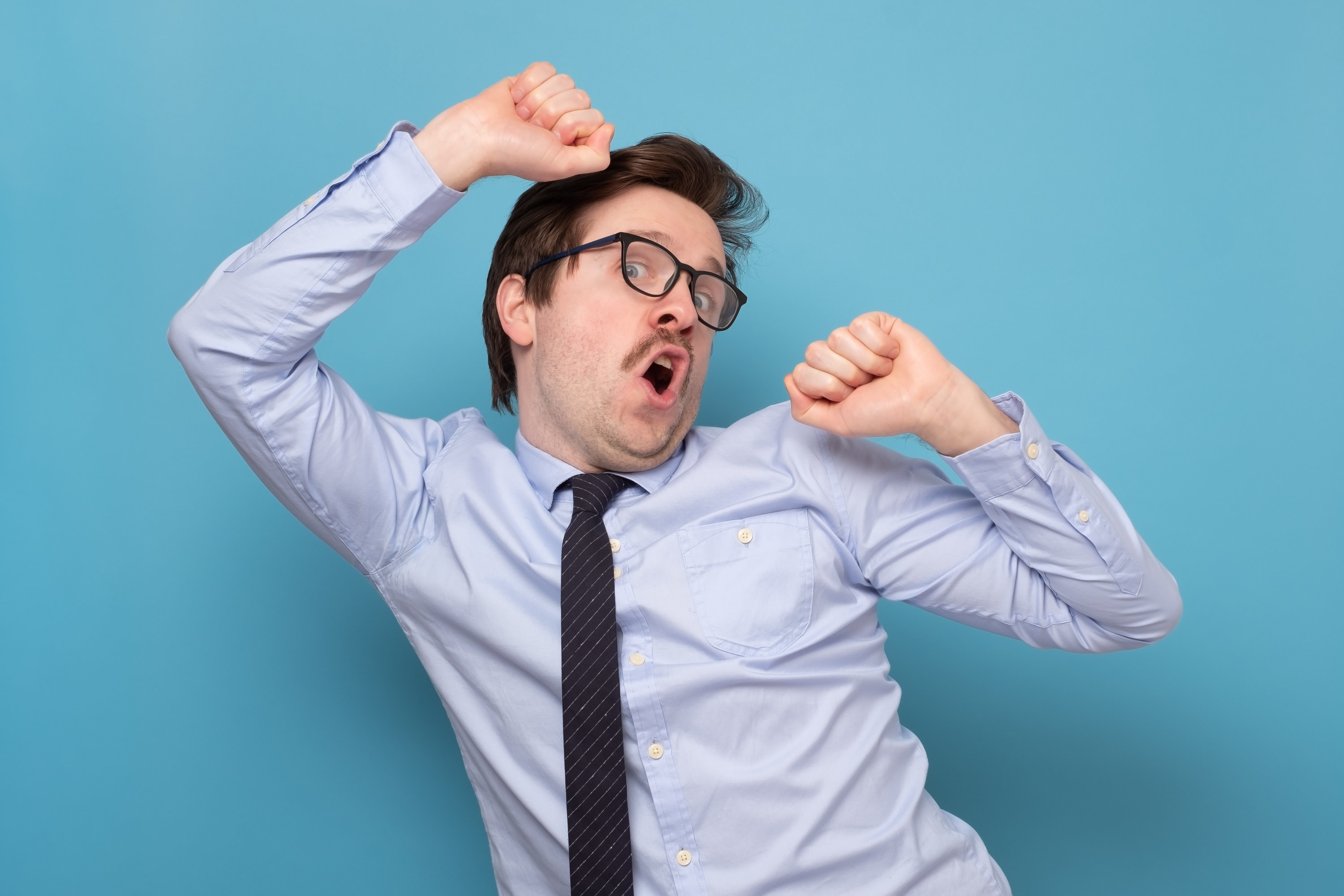 A man in glasses dancing badly