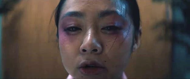 Stephanie Hsu wearing pink eye shadow as wind whips her hair