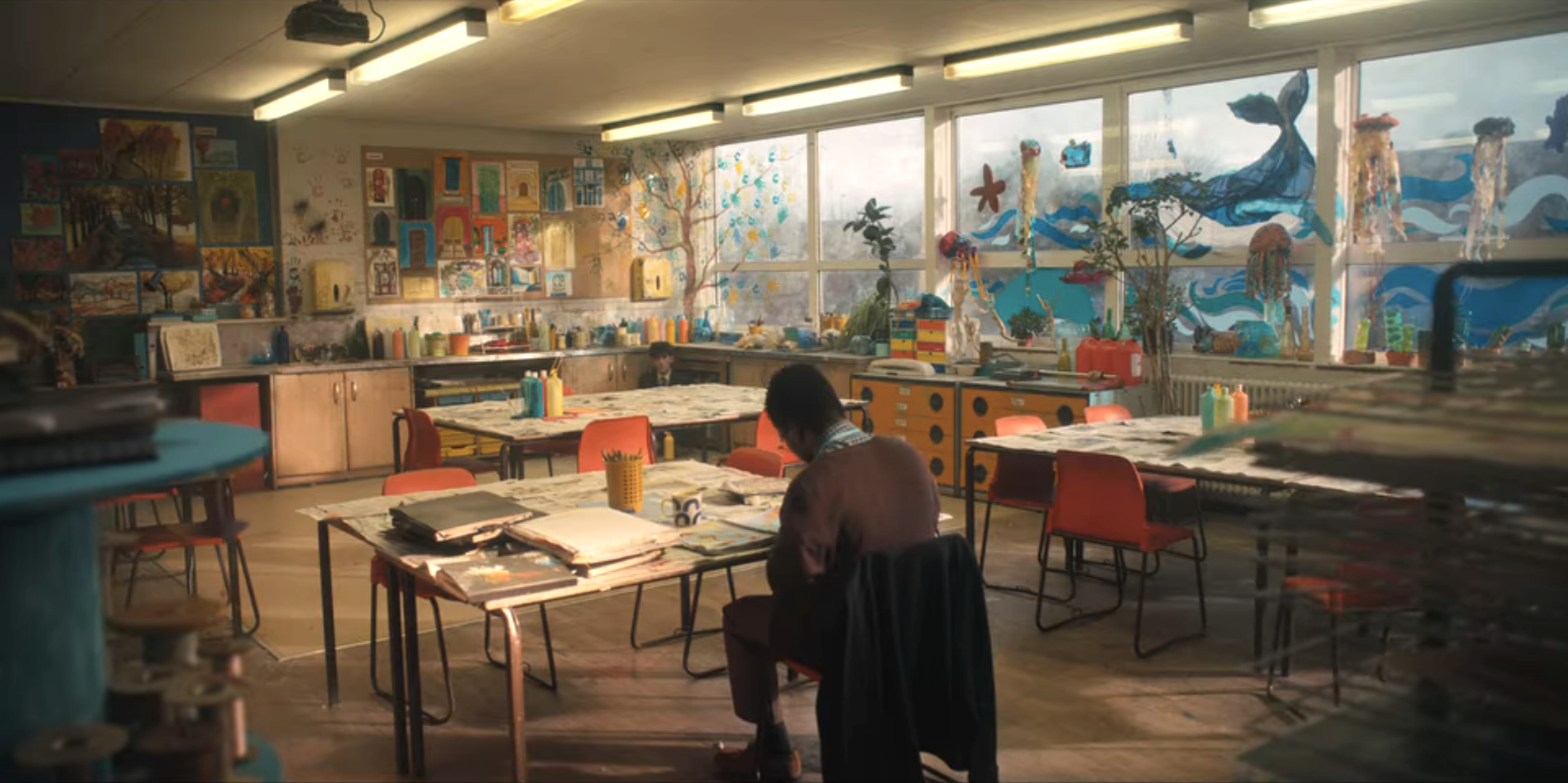 Art room covered in projects and with ocean themed windows