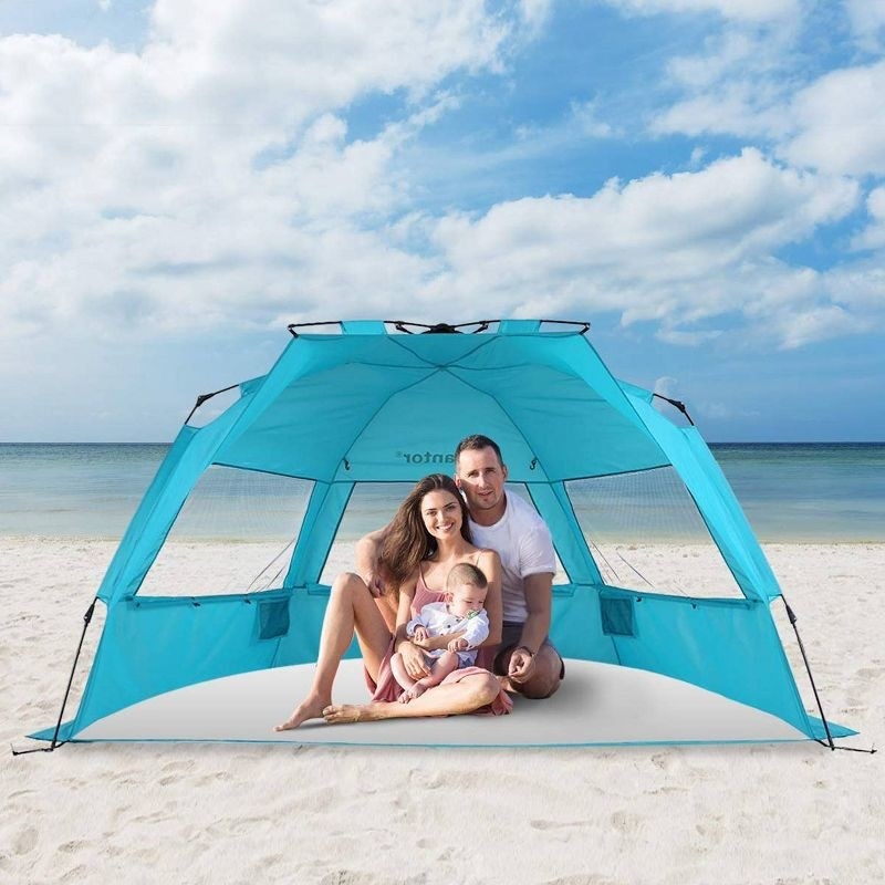Family in pop up tent at the beach