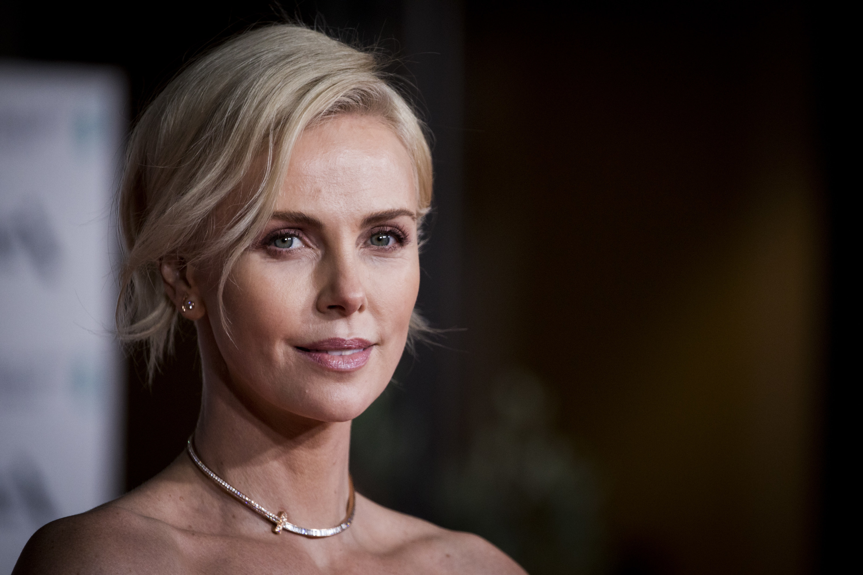 Charlize Theron at an event, smiling