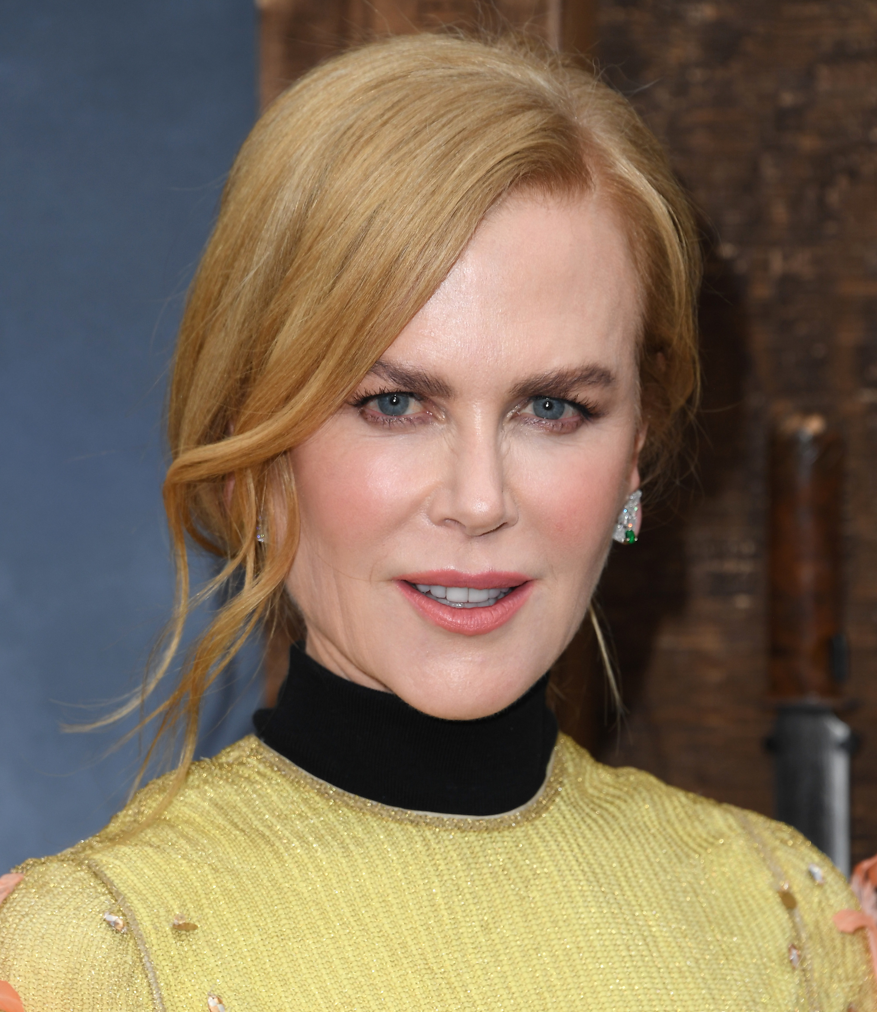 Nicole Kidman at an event, dressed in yellow