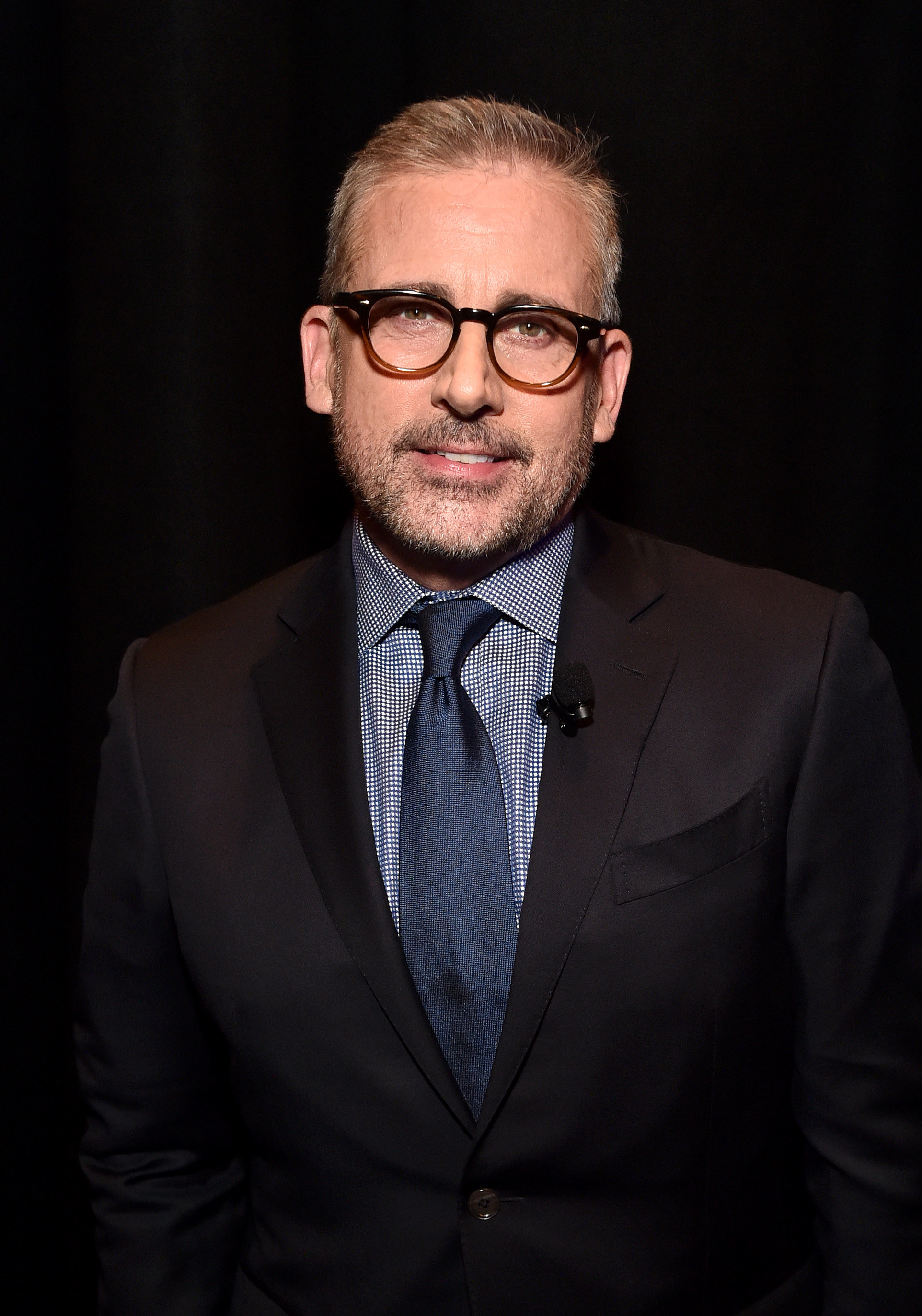 Steve Carell at an event, wearing a black suit