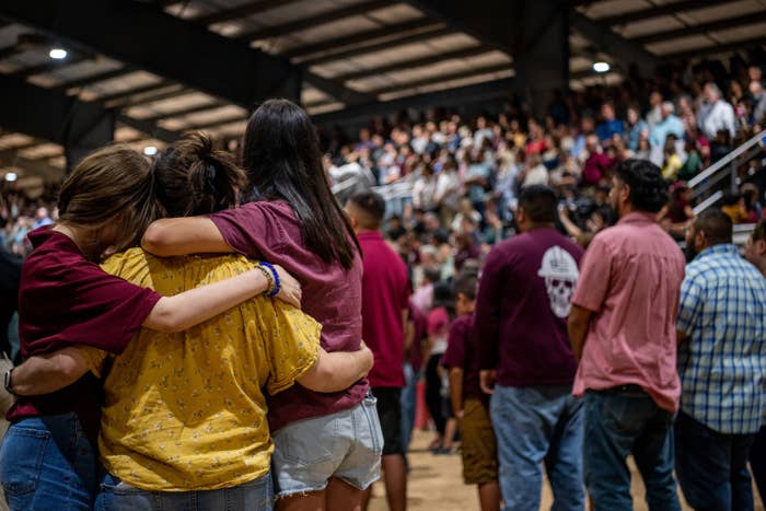 Community members embrace each other at a vigil for the 21 victims in the mass shooting at Robb Elementary School on May 25, 2022 in Uvalde, Texas.