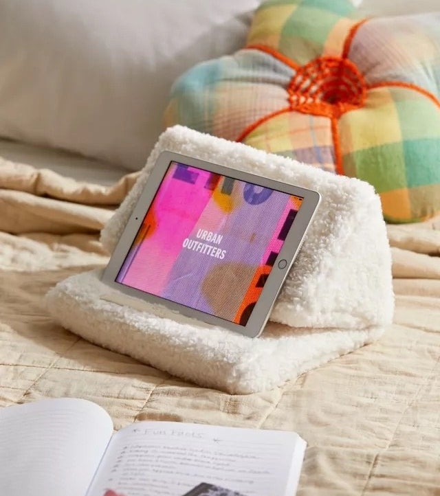 a faux sherpa tablet pillow on a bed