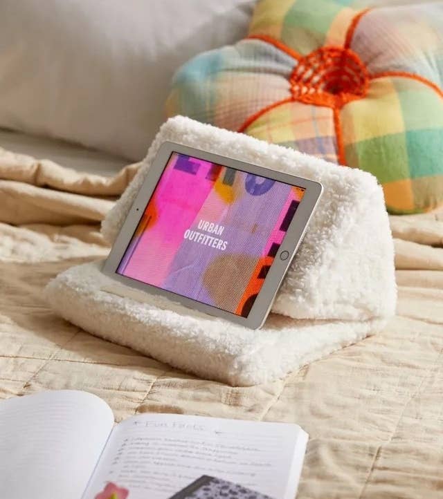 a faux sherpa tablet pillow on a bed