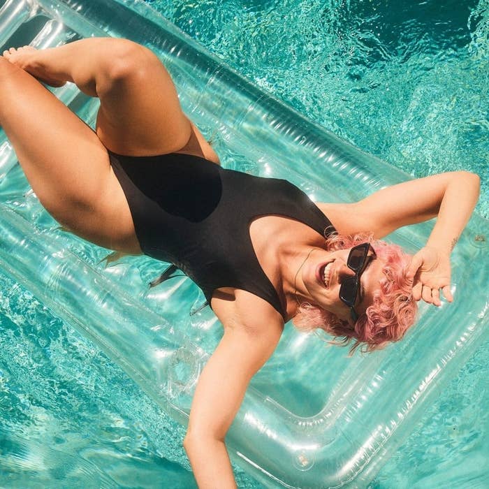 A person wearing the swimsuit while lounging on a pool floatie
