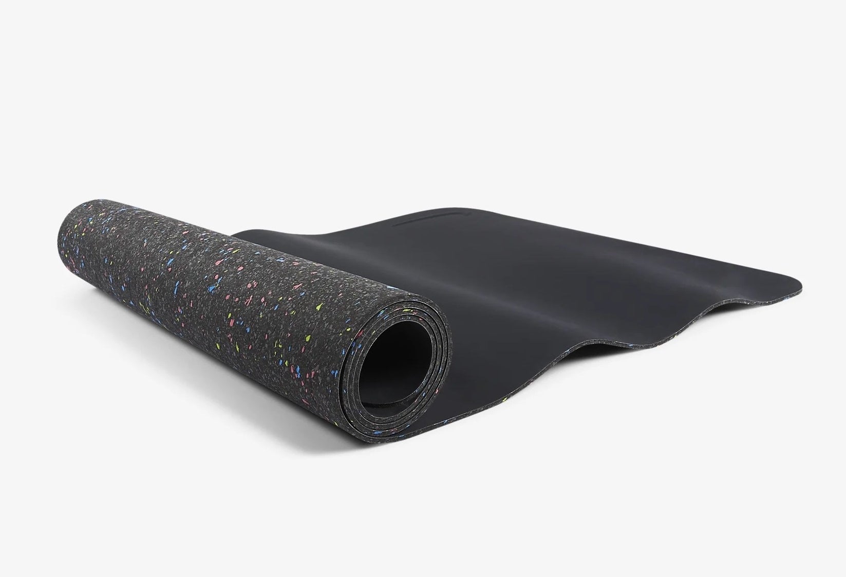 black yoga mat with colorful specks on one side