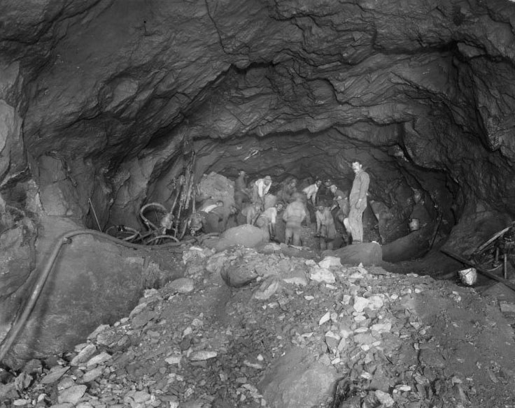 Men work underground, excavating a subway tunnel in NYC