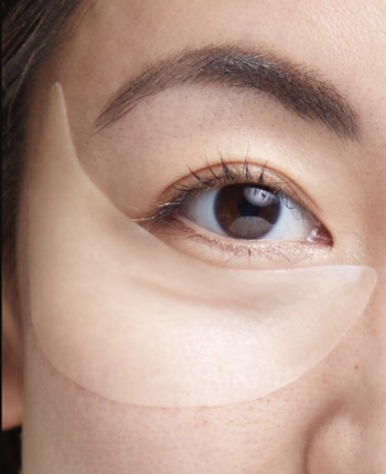 Model with Murad retinol patch on under-eye area