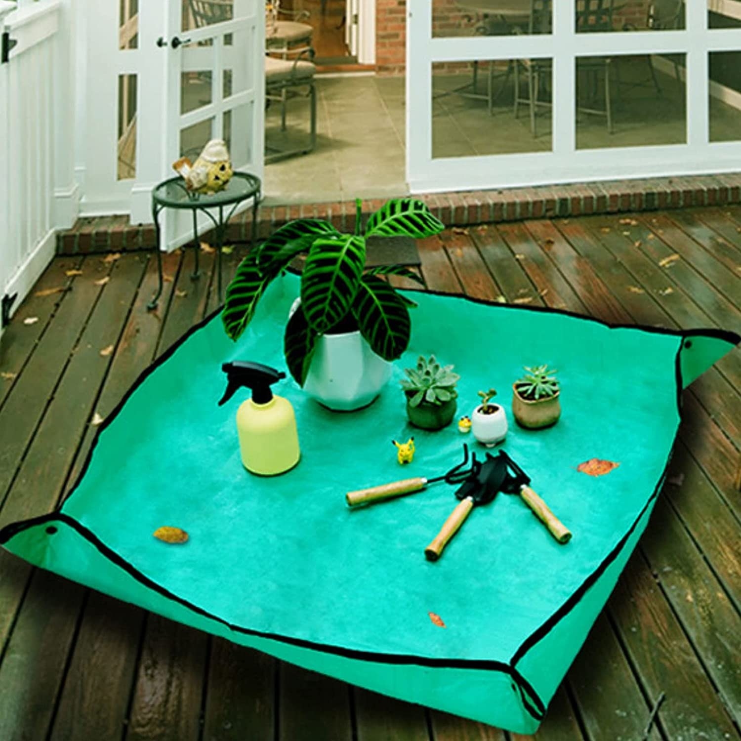 The mat with planting supplies on it while it sits on a deck