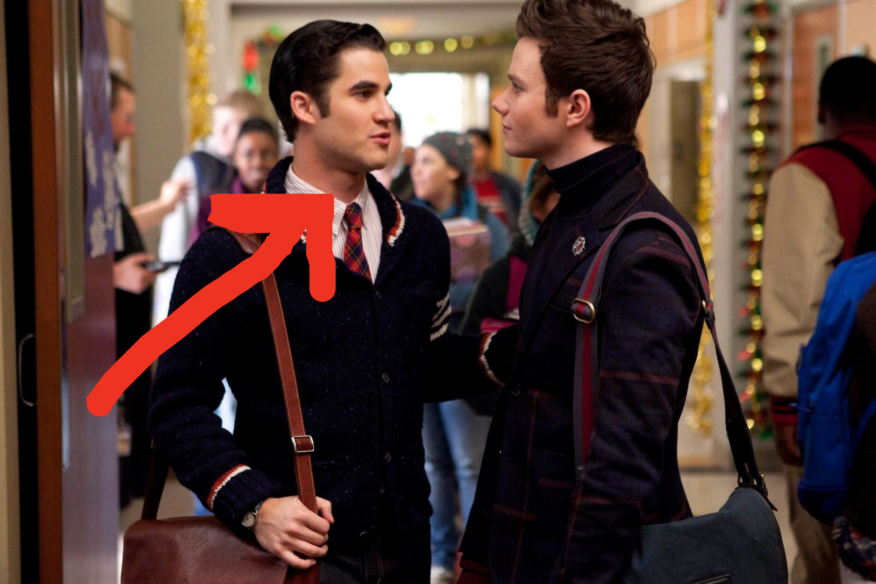 Arrow pointing to Darren, who&#x27;s standing in a hallway talking to another student